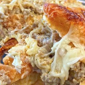 Croissant breakfast bake with sausage, onions, cheese, and eggs