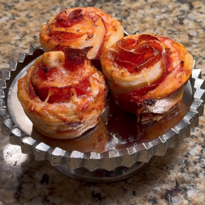 Pepperoni rolls shaped like flowers with marinara and melted cheese